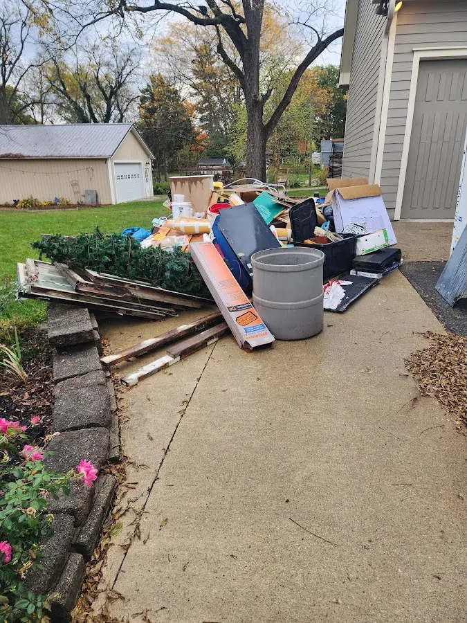 Dumpster being loaded with debris for 30 Yard Dumpster Rental in Grosse Ile